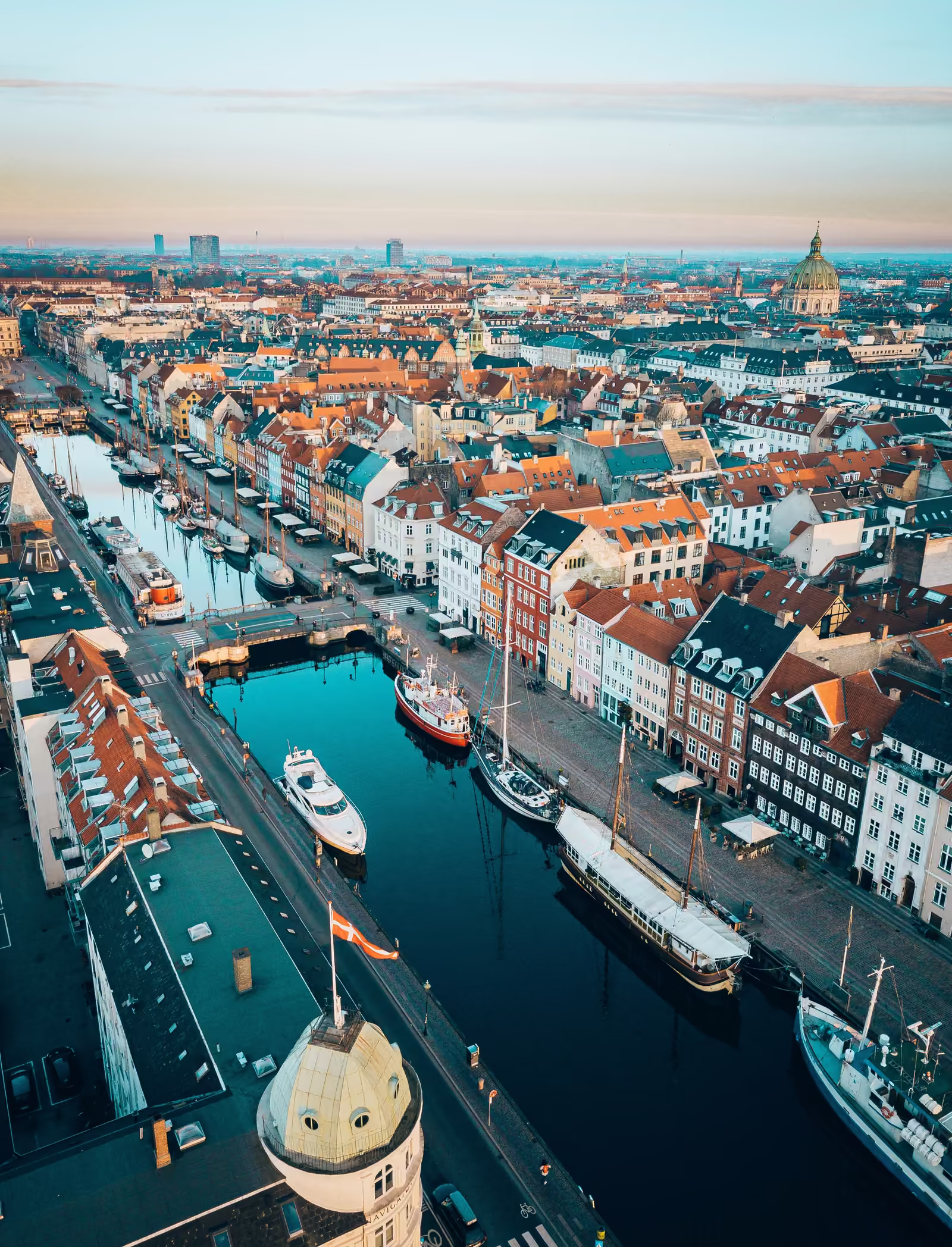 Aerial view of Nyhavn in Copenhagen, with colorful townhouses and boats lining the canal