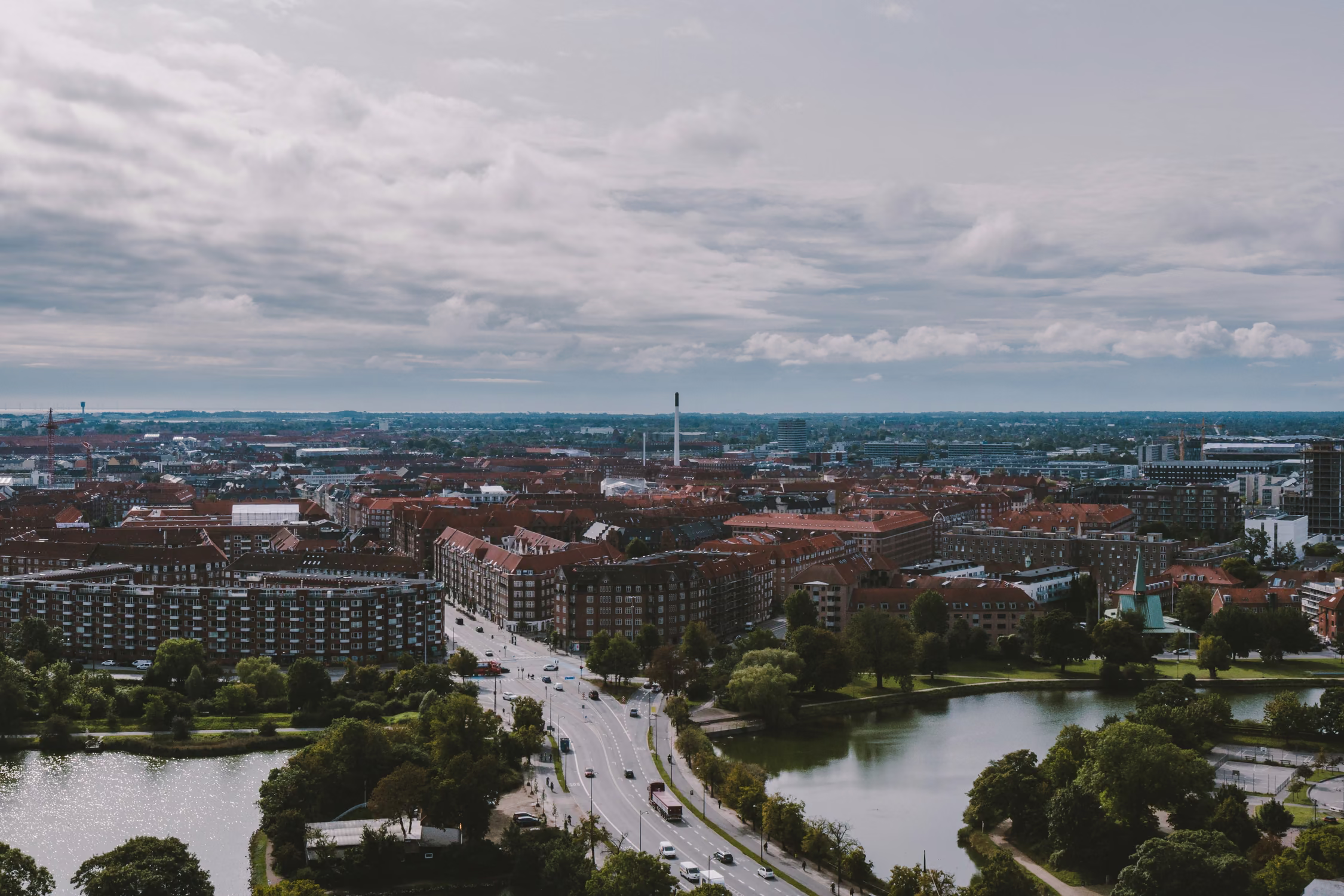 Aerial view of Copenhagen's lakes and the city beyond under a cloudy sky
